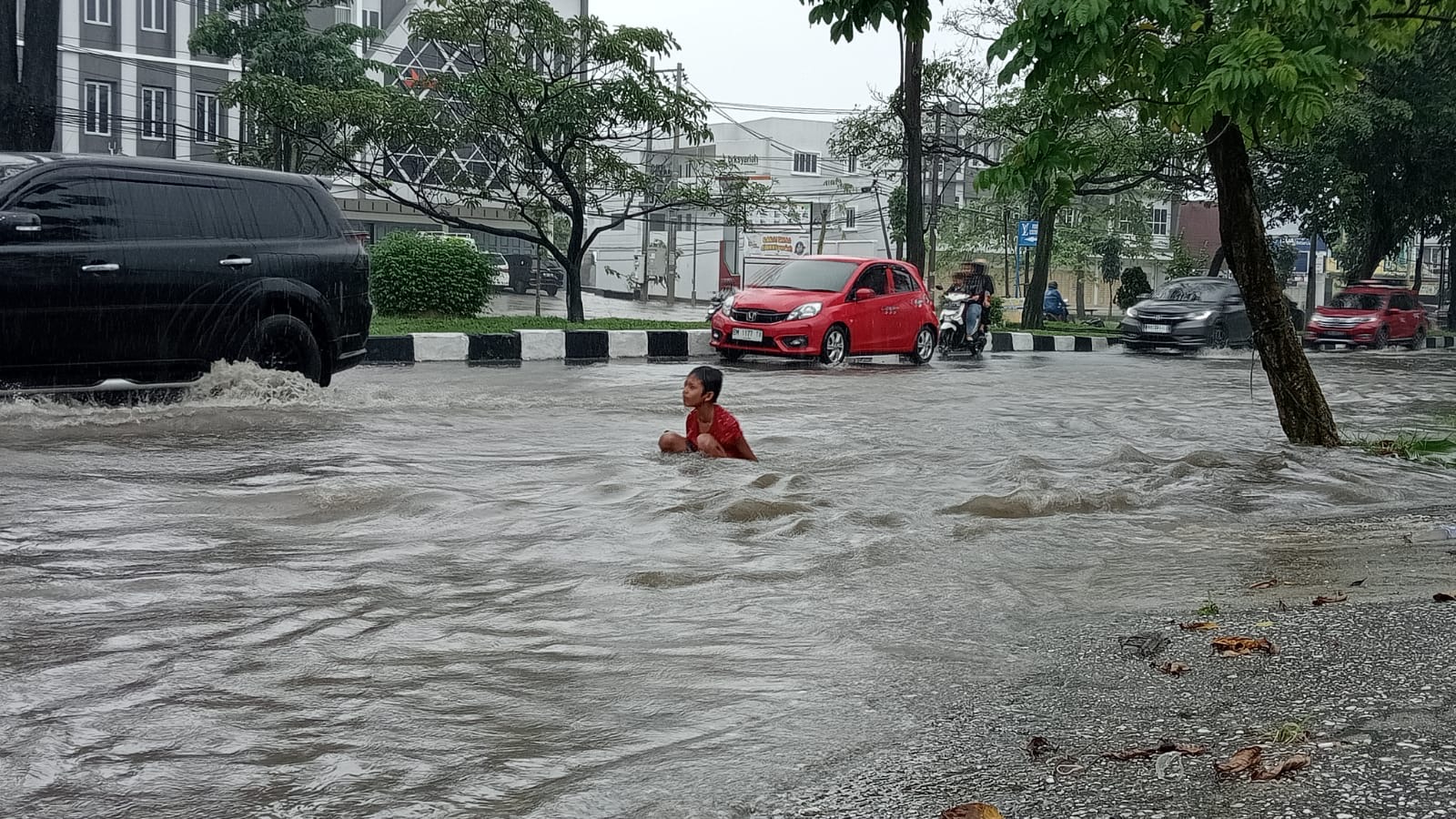 Hujan deras yang mengguyur Kota Pekanbaru menyebabkan sejumlah ruas jalan tergenang, Rabu (14/2/2024).