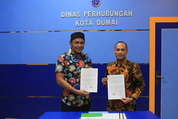 Kepala cabang BPJS Ketenagakerjaan Dumai Legi Handoko Pasaribu dan Kepala Dishub Dumai Saied Effendi SE memperlihatkan MoU kepesertaan ojek online usai ditandatangani, baru-baru ini.