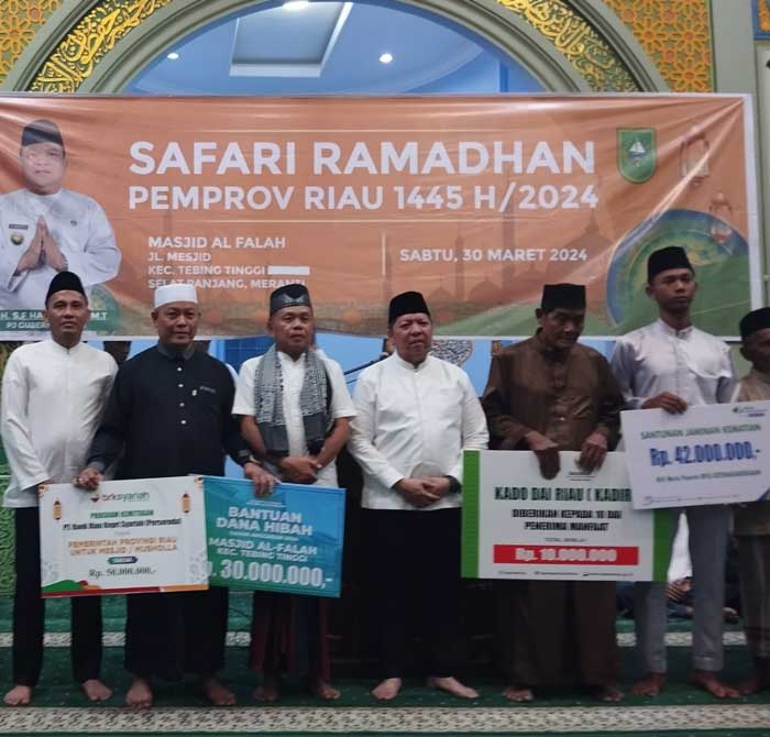 Asisten 1 Setdaprov Riau Masrul Kasmy dan Kepala BPJamsostek Cabang Dumai Legi Handoko foto bersama usai menyerahkan santunan di Masjid Al Falah, Selat Panjang Sabtu (30/3/2024).