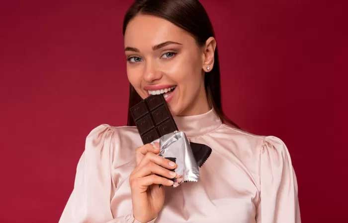 Ilustrasi orang makan coklat hitam.