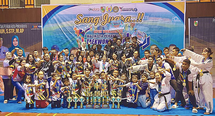 Atlet binaan dojang Eagle Riau Taekwondo foto bersama usai meraih juara umum Kejuaraan Taekwondo Wali Kota Pekanbaru Cup VII di GOR Tribuana Pekanbaru, Ahad (19/5/2024).