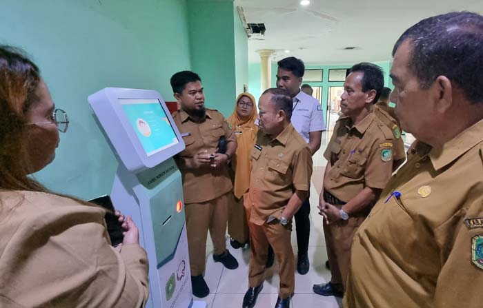 Sekdakab Meranti Bambang Suprianto memantau aplikasi smartphone  yang  difungsikan sebagai pendaftaran pasien UPT  RSUD Kepulauan Meranti, Senin (3/6/2024).