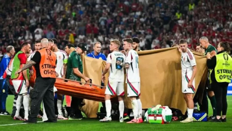 Para pemain membantu memegang kain penutup saat penanganan darurat untuk penyerang Hungaria, Barnabas Varga.