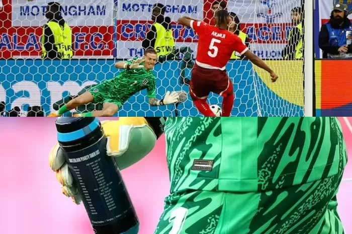 Kiper Inggris, Jordan Pickford, saat berhasil menghentikan tendangan Manuel Akanji dalam drama adu penalti di Euro 2024.