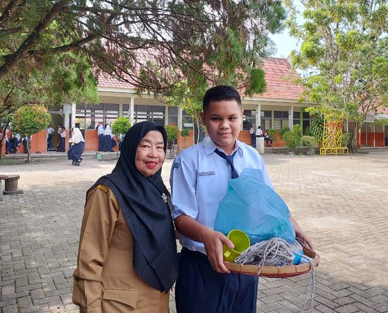 Kepala SMPN 8 Pekanbaru Syafrida Ali SPd foto bersama pelajar di jam istirahat sekolah, Senin (15/7/2024).