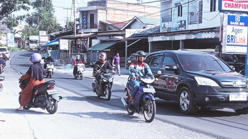 Pengendara melintasi badan Jalan Tengku Bey, Kecamatan Bukit Raya yang mulai dilakukan perbaikan, Selasa (30/7/2024).