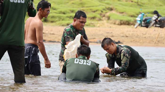 Personel Satgas TMMD ke-121 Kodim 0313/KPR ikut mancokau ikan (menangkap ikan) di lubuk larangan Sungai Subayang Desa Tanjung Belit Selatan.