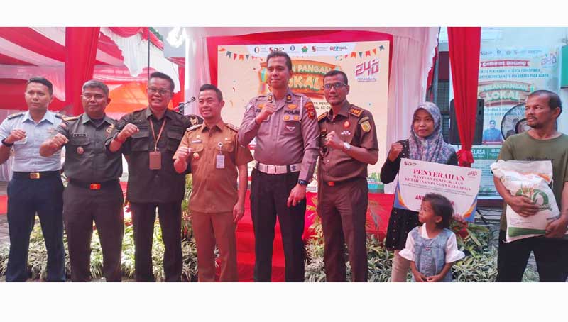 Pj Wako Pekanbaru Risnandar Mahiwa bersama Forkopimda saat penyerahan bantuan kepada sasaran beresiko stunting.