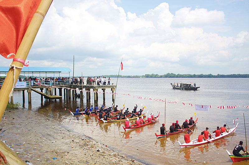 Peserta lomba perahu dayung limo berada di garis awal atau start dalam iven di Sungai Apit, Sabtu (17/8/2024).