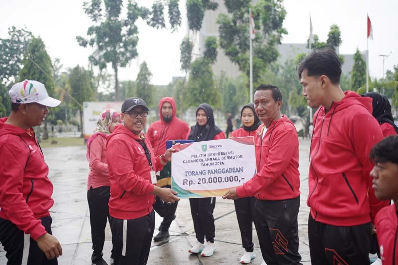 Pelaksana Harian Kepala Dinas Kepemudaan dan Olahraga Riau Helfandi SE MSi mewakili Penjabat Gubernur Riau menyerahkan secara simbolis penghargaan
