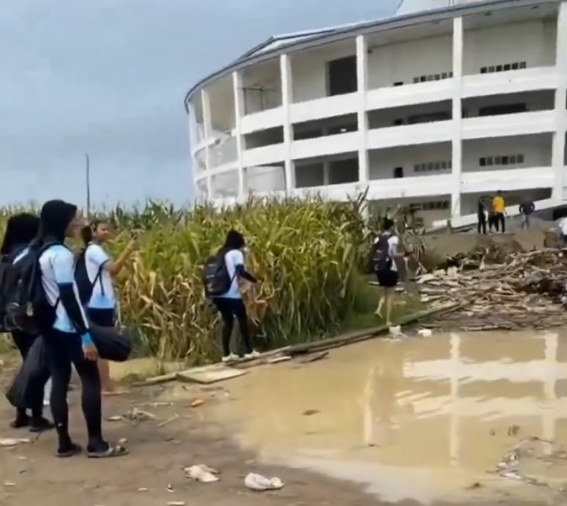 Tangkapan layar beberapa orang atlet saat menuju stadion yang akses jalannya belum selesai.