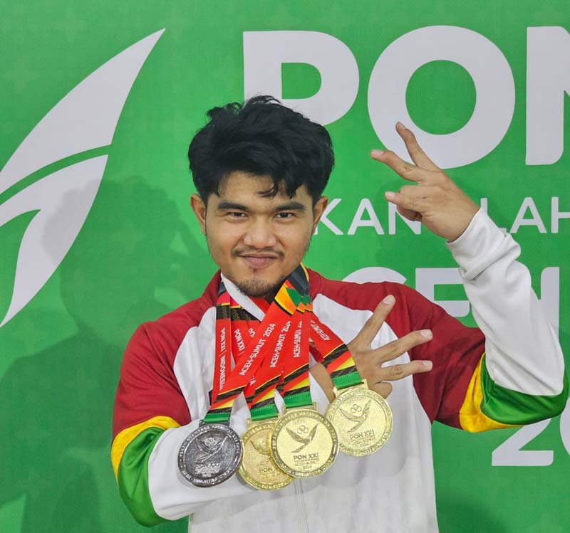 Pesenam Riau Agung Suci Tantio Akbar memperlihatkan medali emas dan perak yang diraih pada PON XXI Aceh-Sumut 2024, baru-baru ini.