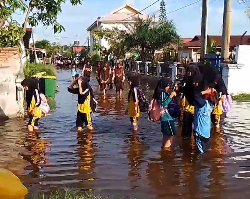Pelajar SMP Negeri 4 Pangkalan Sesai, Kota Dumai dipulangkan lebih awal karena sekolah terendam banjir rob.