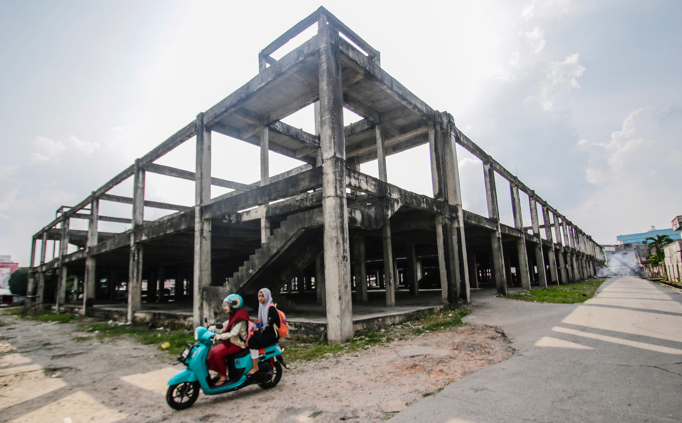 Pengendara melintas di depan Bangunan Pasar Pagi Cik Puan yang tidak selesai pengerjaan, bangunan ini telah dihibahkan aset nya oleh Pemrov Riau ke Pemerintah Kota Pekanbaru, foto iami baru-baru ini.