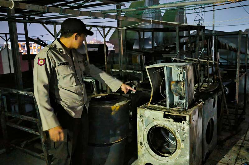 Personel Polsek Bukit Raya memeriksa lokasi kebakaran yang berada di lantai atas Hotel Sabrina City, Kamis (7/11/2024) petang.