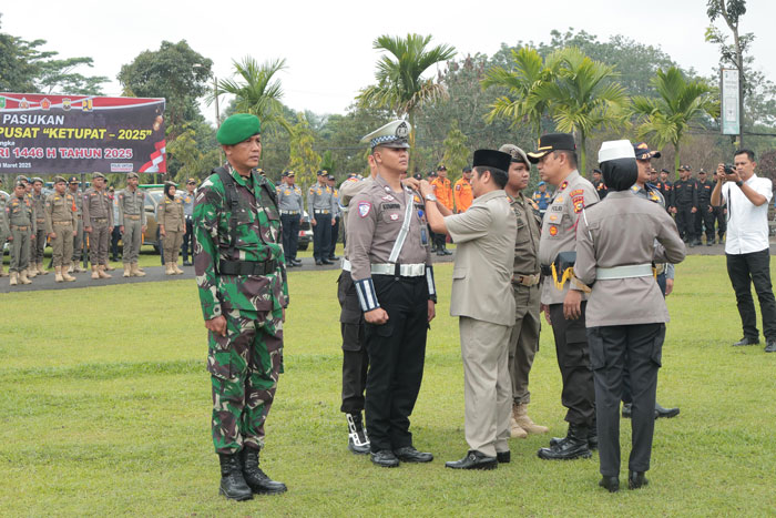 Wakil Bupati Kuansing H Muklisin bersama Waka Polres Kompol Novaldi memasang pita pada personel PAM Idul Fitri 2025, Kamis (20/3/2025) di Mapolres Kuansing.