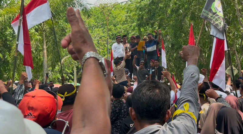 Aliansi Masyarakat Kabupaten Siak/Istana Matahari Timur Menggugat saat beraksi di depan Kantor KPU Siak, Jalan Agraria, Kompleks Perkantoran, Sungai Betung, Siak Sri  Indrapura.
