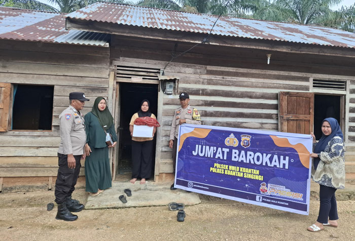 Personel Polsek Hulu Kuantan memberikan bantuan sembako pada warga Desa Mudiak Ulo Kecamatan Hulu Kuantan yang kurang mampu, Jumat (16/5/2025).