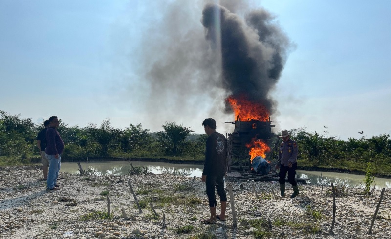 Satu rakit PETI di Desa Koto Rajo Kecamatan Kuantan Hilir Seberang yang sudah ditinggal pemiliknya, Selasa (20/5/2025) dibakar personel Polsek Kuantan Hilir.