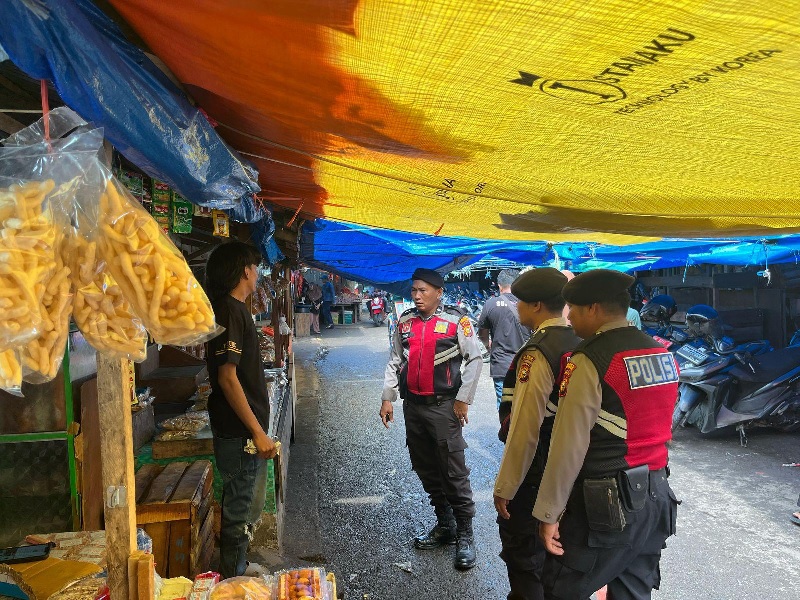 Personel Sat Samapta Polres Inhil melakukan patroli jalan kaki dan berdialog langsung dengan pedagang di pasar Tembilahan, Senin (9/6/2025).
