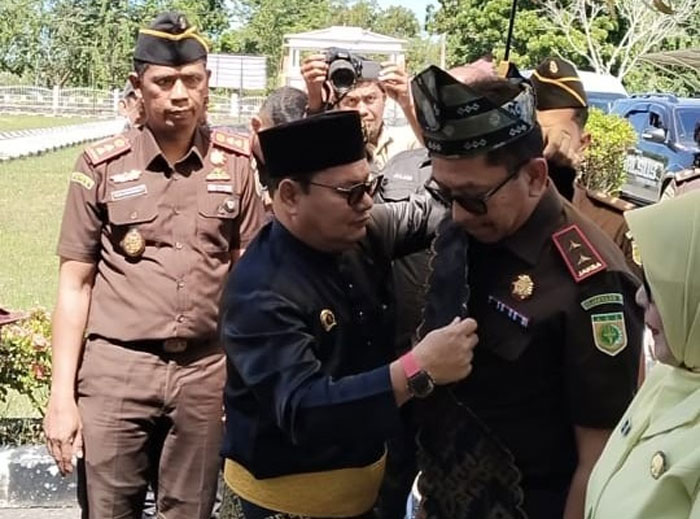Kajati Riau Akmal Abbas dipasangkan tanjak dan selempang oleh Ketum DPH LAMR Rohil Datuk Seri Jufrizan didampingi Kajari Rohil Andi Adikawira pada kunjungan ke Kejari Rohil di Bagansiapiapi.