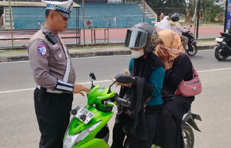 Anggota Satlantas Polres Inhu menilang pengendara sepeda motor akibat tidak memakai helm ganda, Senin (15/7/2025)