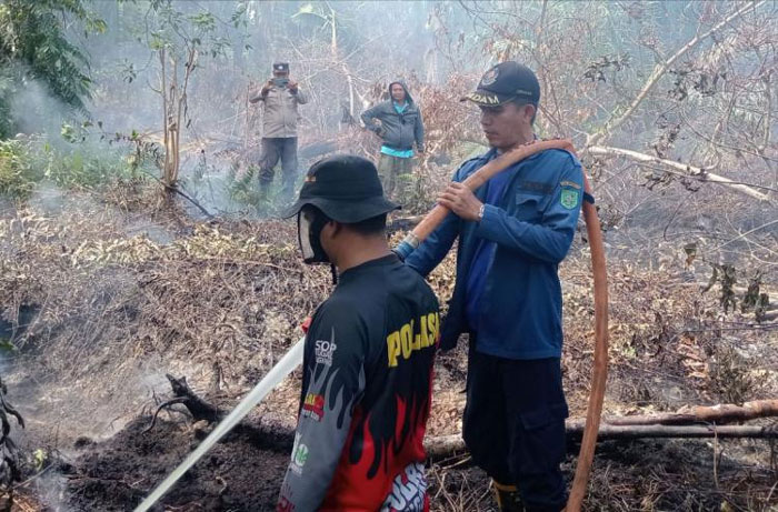 MPA Senggoro dan Polsek Bengkalis, Babinsa Koramil 01 Bengkalis dan Damkar Bengkalis melakukan pendinginan lokasi kebakaran di Jalan Pramuka Gg Perhubugan Dusun 3 Desa Senggoro, Ahad (20/7/2025).