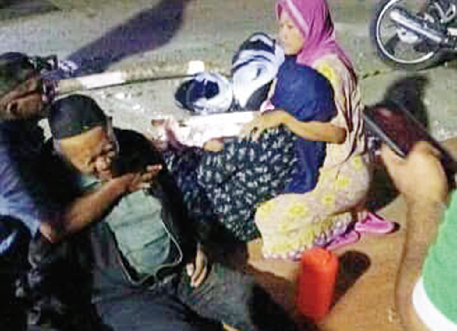 Warga membantu pasangan suami istri yang terjatuh usai menabrak lubang di Jalan Lintas Dumai- Sungai Pakning Dusun Parit Rodi, Desa Bukit Batu Kecamatan Bukit Batu, Sabtu (2/8/2025).malam.