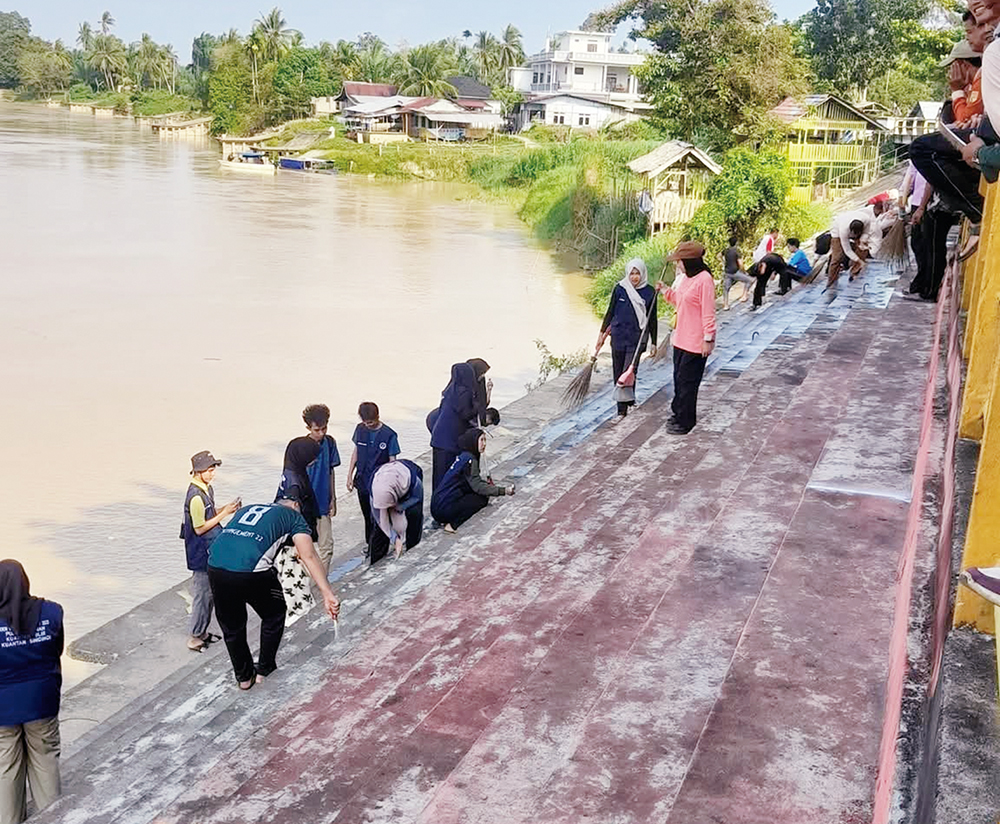 Panitia pacu jalur Bas&shy;rah bersama OPD se-Kecamatan Kuan&shy;tan Hilir dan pemuda, melakukan penge&shy;catan tribun tangga batu di Tepian Lu&shy;buak Sobae Basrah, Kecamatan Kuantan Hilir, Ahad (3/8/2025).