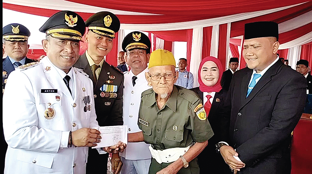 Bupati Rohul Anton ST MM bersama Wabup H Syafaruddin Poti SH MM didampingi forkopimda menyerahkan tali asih kepada veteran Rohul bernama Jabal (113) usai upacara peringatan Detik-Detik Proklamasi