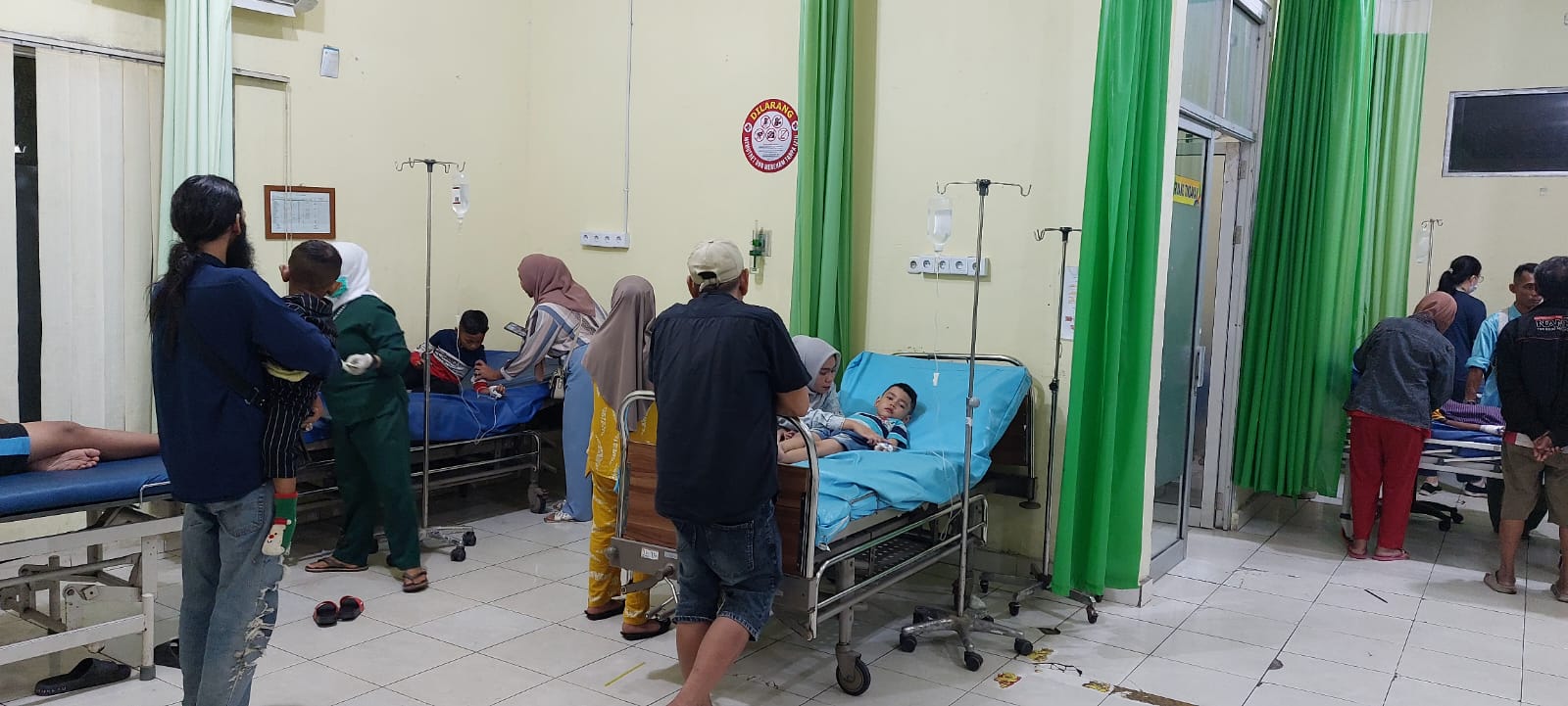Terlihat para korban diduga keracunan makanan dari dapur MBG sedang menjalani perawatan di ruang IGD RSUD Puri Husada, Tembilahan, Jumat (23/8/2025) malam.
