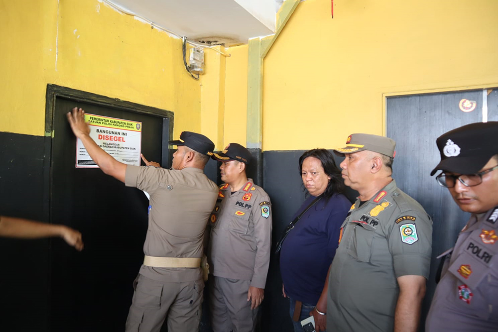 Kasatpol PP Winda (dua kanan) menyegel tempat hiburan malam di Perawang, Kecamatan Tualang, Selasa (26/8/2025)