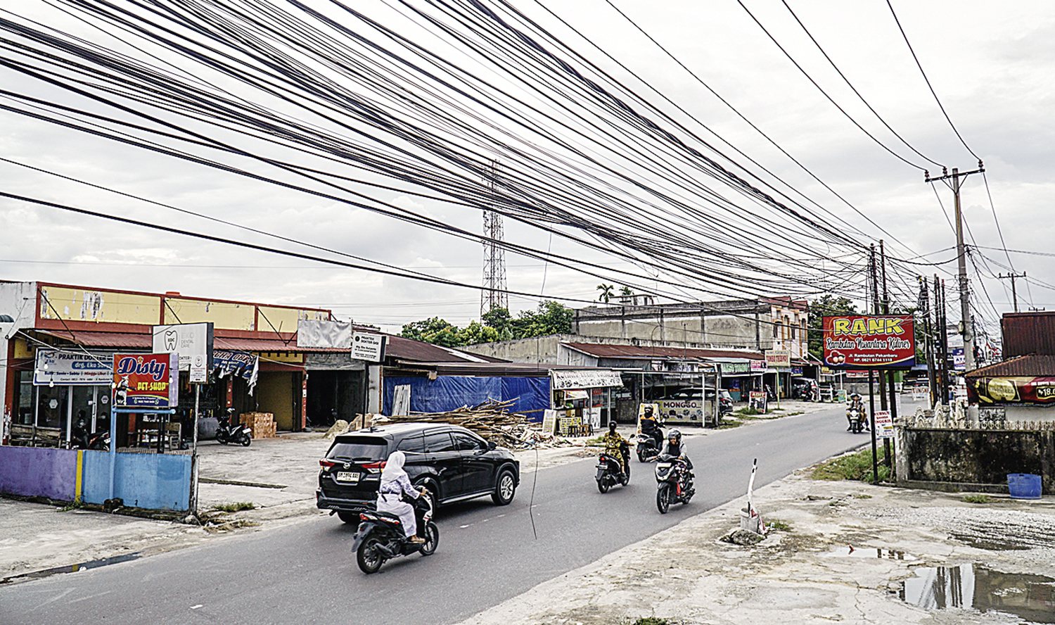 Jaringan kabel fiber optik yang semraut di kawasan Jalan Rambutan, Pekanbaru, Senin (22/9/2025).
