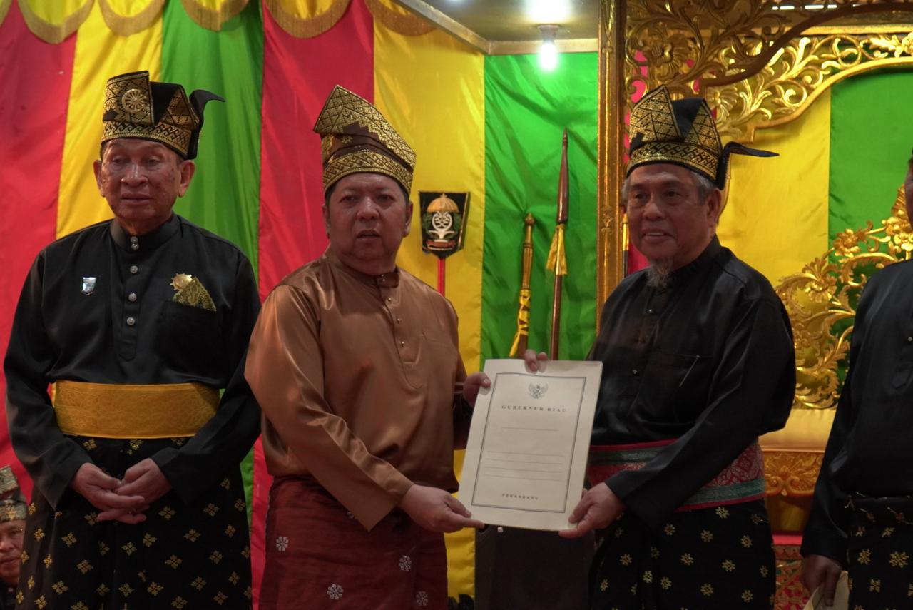 Asisten I Setdaprov Riau Zulkifli Syukur menyerahkan dukungan terhadap DIR di Balai Adat LAMR, Jumat (17/10/2025).