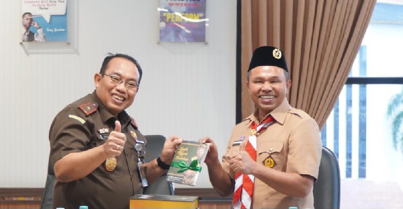 Senyum merekah Plt Kajati Riau Dedie Tri Hariyadi saat menerima buku Syair dan Tunjuk Ajar Melayu dari Gubernur Riau Abdul Wahid, Senin (20/10/2025).