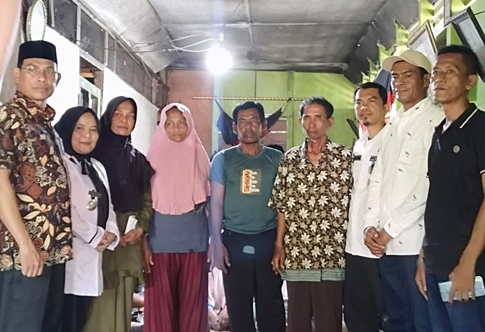 (Dari kiri) Komisioner Baznas Rohil Ustad Ramli SPdI MPdi, Lurah Bagan Hulu Sri Indrayani bersama keluarga nelayan yang dilaporkan hilang di perairan Rohil usai penyerahan bantuan di Bagansiapiapi