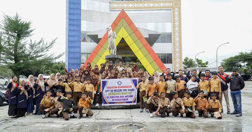 Guru dan murid dari UPT SDN 010 Siabu foto bersama saat kegiatan edukatif di Riau Pos, Rabu (17/12/2025).