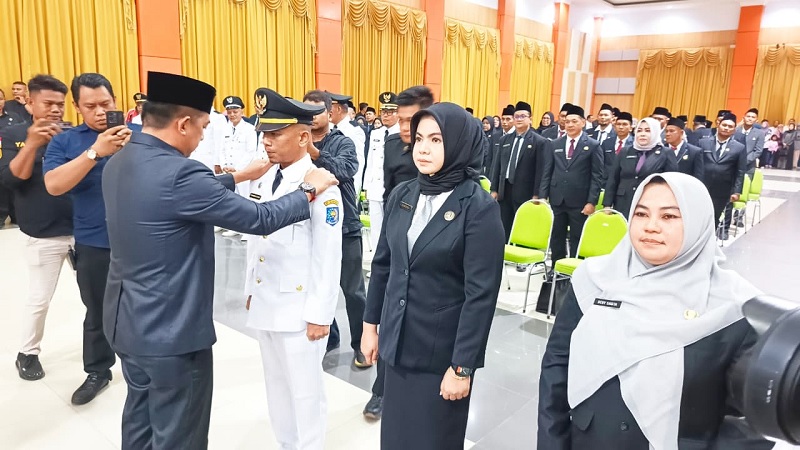 Sekdakab Inhu Zulfahmi Adrian AP MSI memasangkan tanda pangkat kepada salah seorang pejabat yang dilantik, Rabu (31/12/2025)