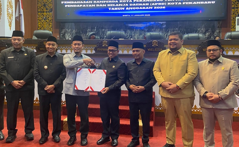 Ketua DPRD Kota Pekanbaru Muhammad Isa Lahamid dan Wali Kota Pekanbaru Agung Nugroho memperlihatkan berita acara pengesahan APBD 2026 usai sidang paripurna pada Sabtu (17/1/2026) malam.