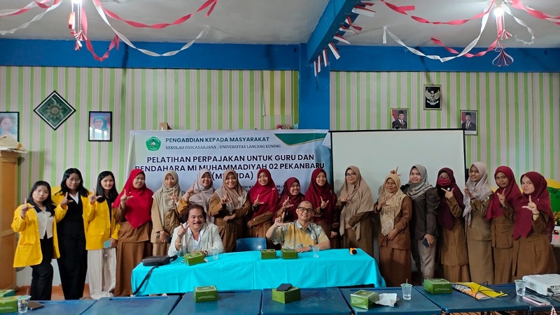 Tim PKM Unilak Dr Jeni Wardi SE MAk Ak CA dan Dr Imran Al Ucok Nasution ST MM beserta guru foto bersama usai pelatihan perpajakan di MI Muhammadiyah 02 Pekanbaru.