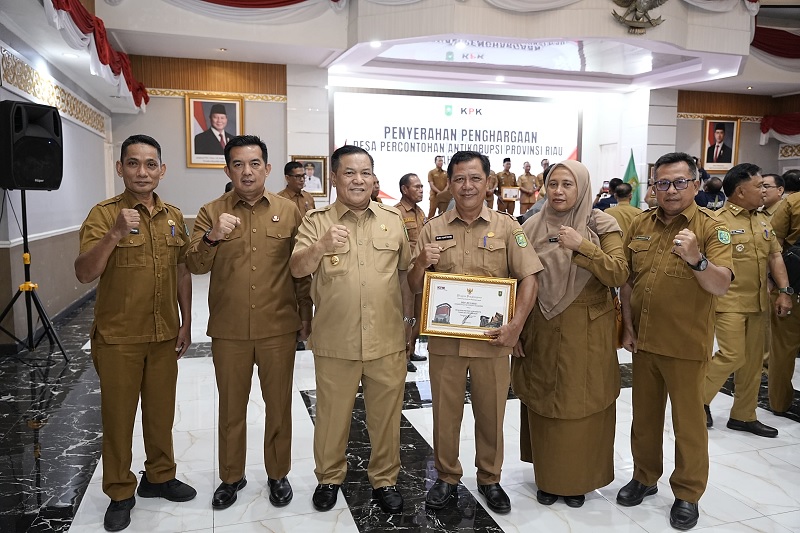 Sekdakab Inhu, Zulfahmi Adrian (dua kiri) foto bersama dengan Plt Gubernur Riau, SF Hariyanto, Kades Kelawat, Budi Haryono serta Kepala OPD terkait usai menerima penghargaan, Senin (26/1/2026),