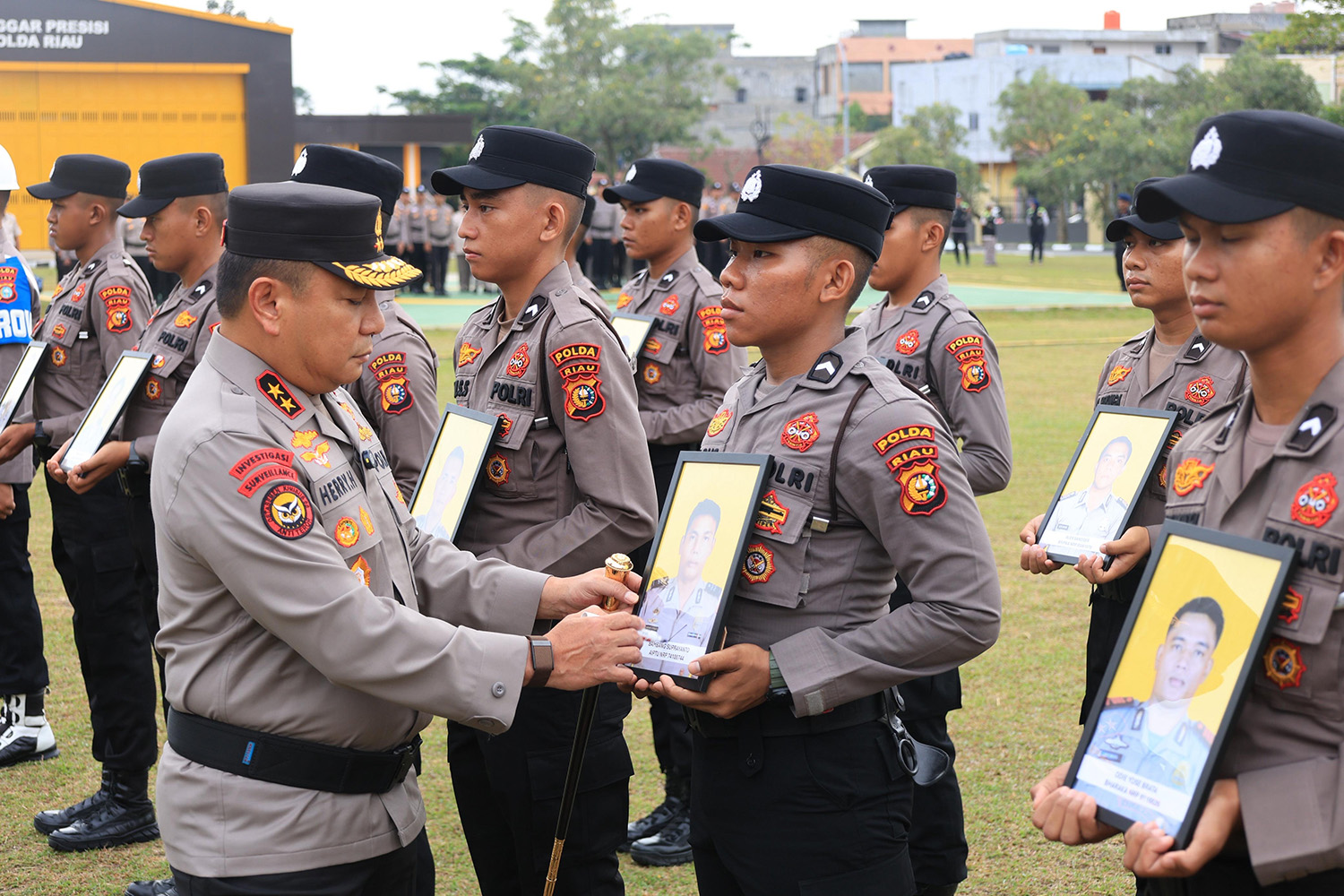 Kapolda Riau Irjen Pol Herry Heryawan saat mencoret foto dari anggota yang dipecat sebagai simbol telah dikeluarkan dari kepolisian, Kamis (29/1/2026).