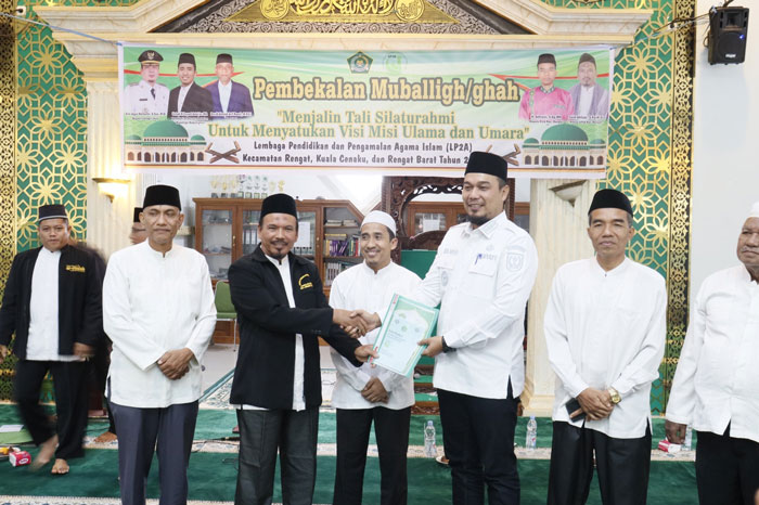 Bupati Inhu Ade Agus Hartanto saat menyerahkan secara simbolis buku panduan Safari Ramadan kepada salah seorang mubalig, Ahad (8/2/2026).