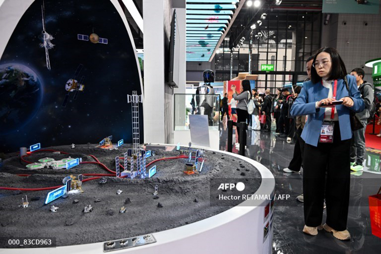 Visitors look at a scale model of the International Lunar Research Station at China