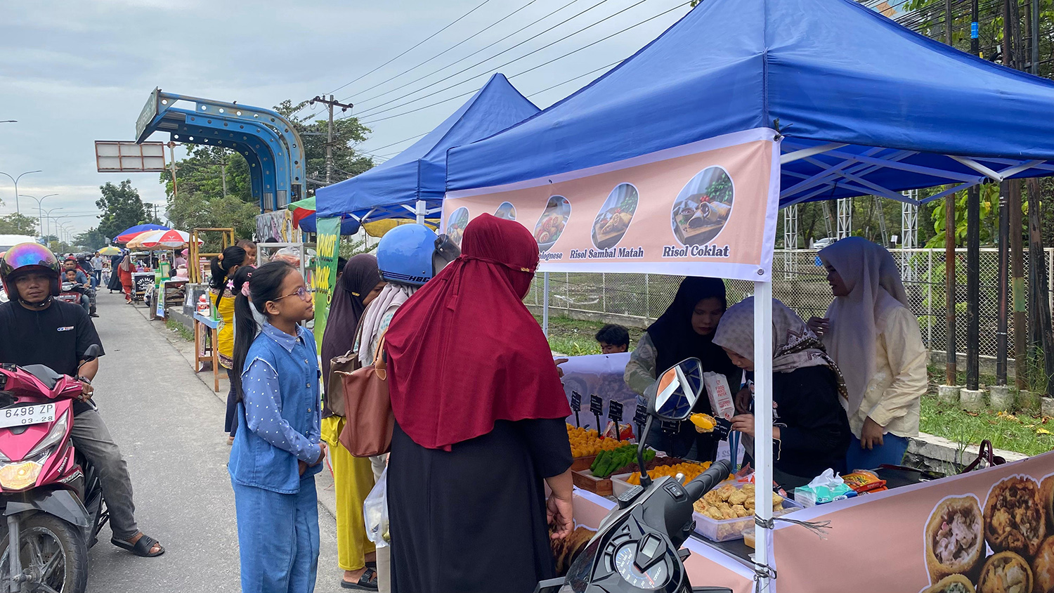 Warga membeli menu takjil yang dijual pedagang di depan gerbang Kampus Unri, Jalan HR Soebrantas, Kamis (19/2/2026).