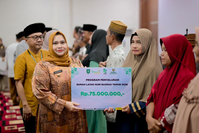 Bupati Bengkalis Kasmarni menyerahkan bantuan dana untuk rumah layak huni saat Safari Ramadan Perdana 1447 H di Kecamatan Talang Muandau, Senin (23/2/2026).