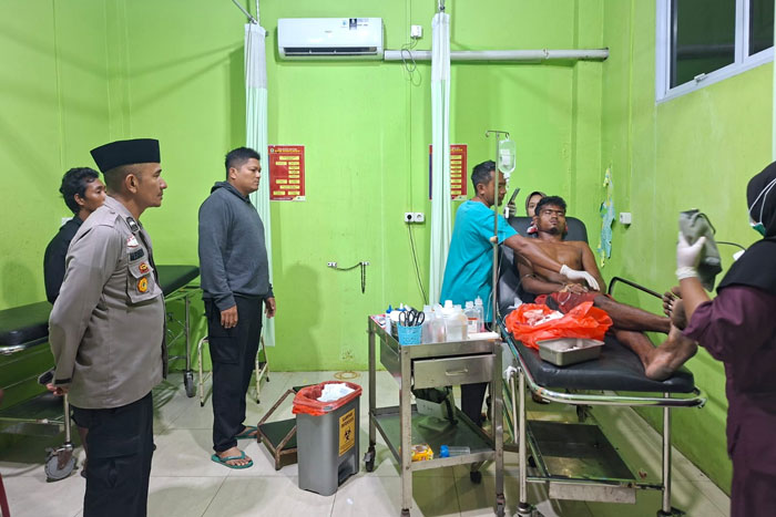 Personil Polsek Kuala Kampar meninjau kondisi Kohai warga Desa Teluk Kecamatan Kuala Kampar di Puskesmas setempat setelah menjadi korban serangan harimau di area dermaga PT SPA Serapung.
