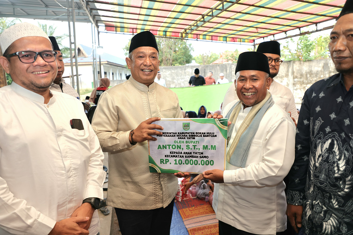 Bupati Rohul Anton ST MM menyerahkan bantuan santunan anak yatim se-Kecamatan Rambah Samo kepada Camat H Zulbahri dalam kunjungan Safari Ramadan di Masjid Darul Istiqomah.