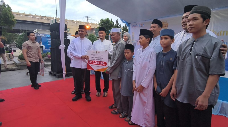 Wako Pekanbaru Agung Nugroho didampingi Wawako Pekanbaru Markarius Anwar dan Ketua TP PKK Pekanbaru Sulastri Agung memberikan bantuan pada Peringatan Nuzulul Qur'an dan Safari Ramadan di Masjid Agung.