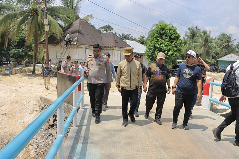 Kapolres Kampar AKBP Bobby Putra Ramadhan Sebayang mendampingi Bupati Ahmad Yuzar saat meninjau lokasi Jembatan Merah Putih Presisi di Desa Gobah, Kecamatan Tambang, Sabtu (7/3/2026).